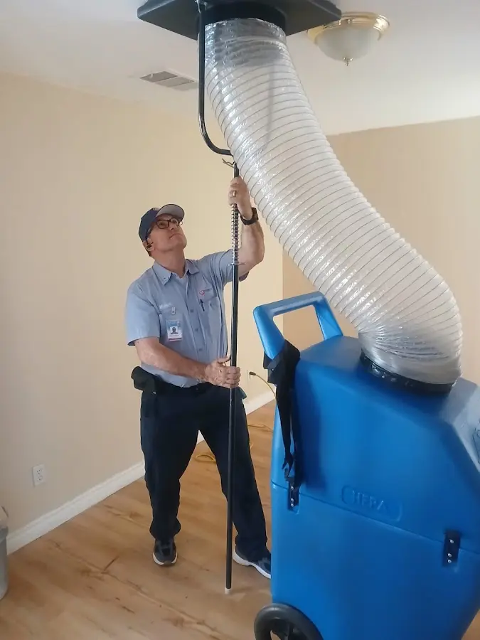 Furnace Tune-Up technician using HEPA equipment in Hyrum